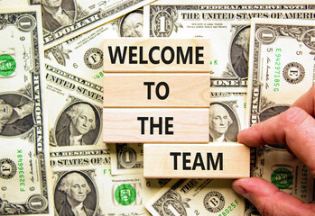 Welcome to the team symbol. Concept words Welcome to the team on wooden block. Dollar bills....
