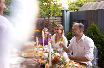 Many people saying cheers and showing their champagne glasses. Wedding party