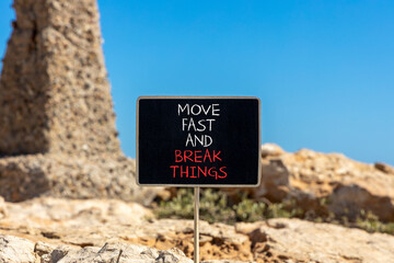 Move fast and break things symbol. Concept words Move fast and break things on beautiful blackboard. Beautiful stone sky background. Business, move fast and break things concept. Copy space.