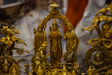Fototapeta na wymiar Brass metal art, Handmade Indian God Ram idol souvenir made with brass with blur background. Selective focus.