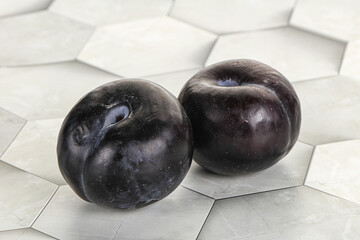 Two ripe sweet black plums