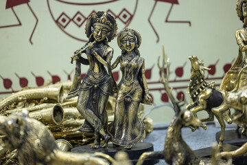 Brass metal art, Handmade Indian God Krishna sculpture souvenir made with brass with plain background. Selective focus.