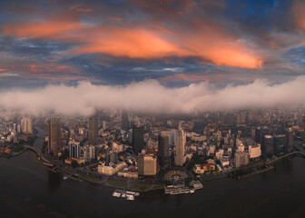 Aerial photo of downtown Ho Chi Minh City, Vietnam's largest city with high-rise buildings next to the riverbank.