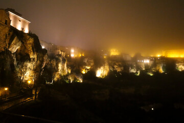 The ancient city of Cuenca covered by fog at night