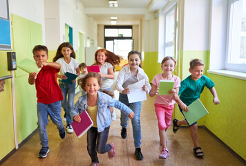 Schoolkids running in hallway during recess