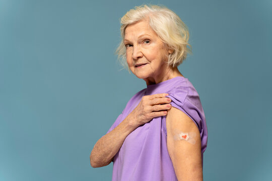 Side view of elderly caucasian woman with medical plaster on hand