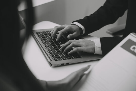 Closeup asian male people car salesman or sales manager offers to sell a car and explains and reads the terms of signing a car contract and insurance.