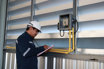 chief engineer in modern industrial factory using tablet and making audit.