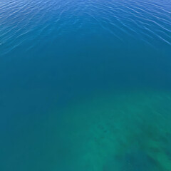 Obraz premium Ocean surface on an island in California with gentle ripples on the surface and refraction of light, clear water, stones at the bottom of the sea, clean environment concept,