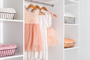 White dressing room with elegant lush dresses. Storage organization concept.