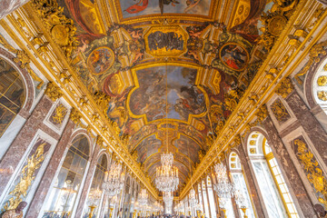 Fototapeta na wymiar Hall of Mirrors. Decorated interior with historical furniture and architectural details of Chateau Versailles near Paris, France
