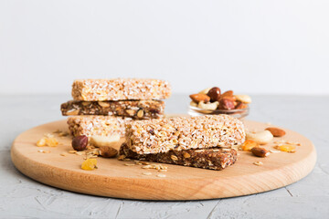 Various granola bars on table background. Cereal granola bars. Superfood breakfast bars with oats, nuts and berries, close up. Superfood concept