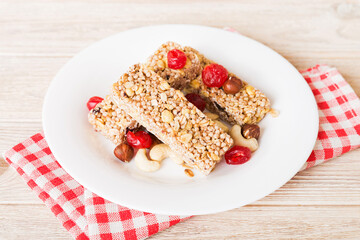 Various granola bars on table background. Cereal granola bars. Superfood breakfast bars with oats, nuts and berries, close up. Superfood concept