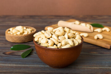 cashew nuts in wooden bowl on table background. top view. Space for text Healthy food