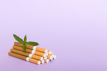 Menthol cigarettes and fresh mint leaves on colored background, Many cigarettes stacked together top view flat lay