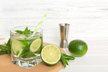 Fototapeta premium Mojito cocktail. Refreshing mojito cocktail with lime, lemon and mint in a tall glass with a stick
