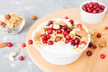 Healthy breakfast food with granola, yogurt, fruits and nuts. Dessert parfait with dried fruits for breakfast