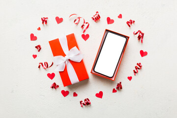 Opened gift box with ribbon and phone on color background, top view. Blank open box packaging mockup , Template for your design - branding mockup