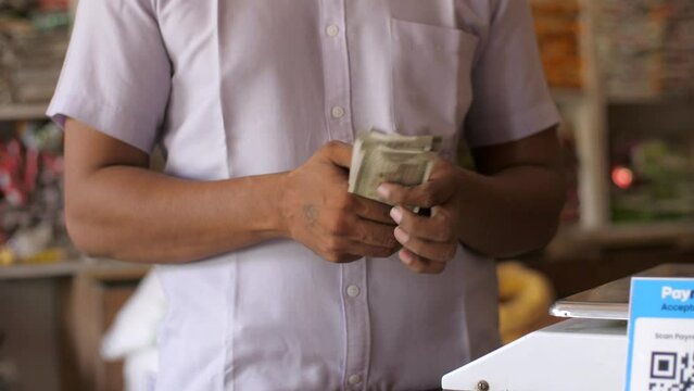 Closeup of counting money or currency notes or cash - concept of tax savings  business profits  finance and banking. A businessman counting his income for the day - finance and money  earning money...