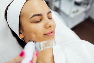Caucasian woman getting face peeling procedure in a beauty clinic