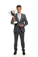 Obraz premium Businessman standing with pride holding a trophy isolated over white background.