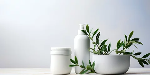 Poster Mock up of natural beauty products. White cosmetic bottles with green leaves on a light neutral background. Soft image and soft focus style. Organic cosmetic products. © Sasha