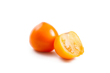 Whole and half of yellow tomato isolated on white background.