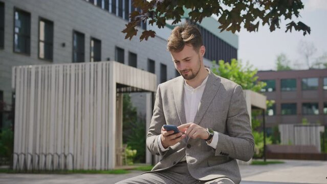 Businessman Using Smartphone in Park