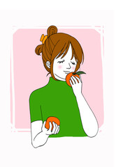 オレンジの香りを楽しむ女性