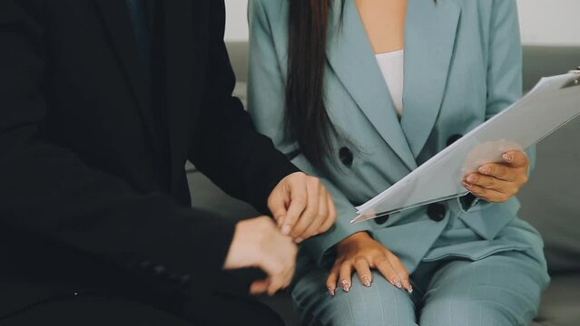 Beautiful young woman being victim of sexual harassment at workplace, copy space. Male boss touching his female secretary without permission at office. Corporate discrimination concept