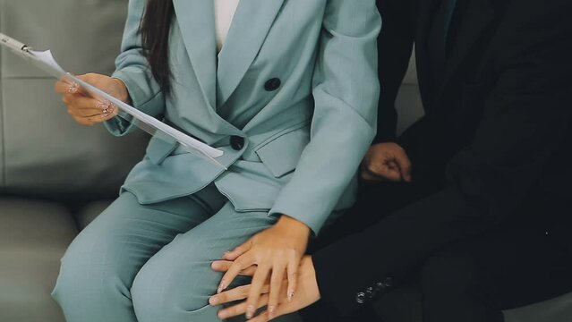 Beautiful young woman being victim of sexual harassment at workplace, copy space. Male boss touching his female secretary without permission at office. Corporate discrimination concept