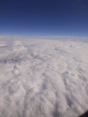 Naklejka premium Fluffy clouds top view of the airplane Heavenly landscape
