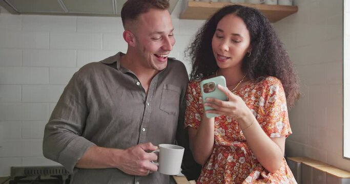 Couple, kitchen and laughing for social media on phone, happy and relaxing together for bonding. People, drinking coffee and mobile application for online humor, tea and love in relationship at home