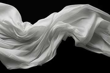  a black and white photo of a white cloth blowing in the wind on a black background with space for a text or a logo on the bottom right side of the image.