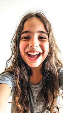 Selfie phone photo of a portrait of a teenage girl making a selfie with an expression of happiness on a white background. Concept of Youthful Joy, Self-Expression, and Social Media Moments.