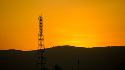 Obraz premium Silhouette, communication tower on sunset background