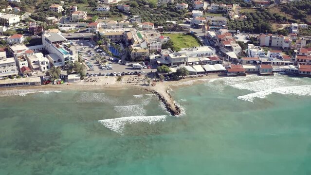Aerial view of Kalives beach and the seafront buildings in Kalyves village in Crete island, Greece