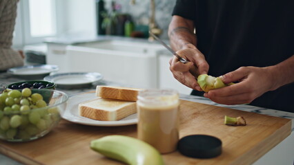 Guy hands removing banana peel kitchen close up. Unknown man preparing breakfast
