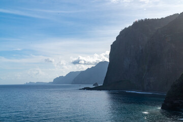 Waves crashing into the cliffs of madeira island