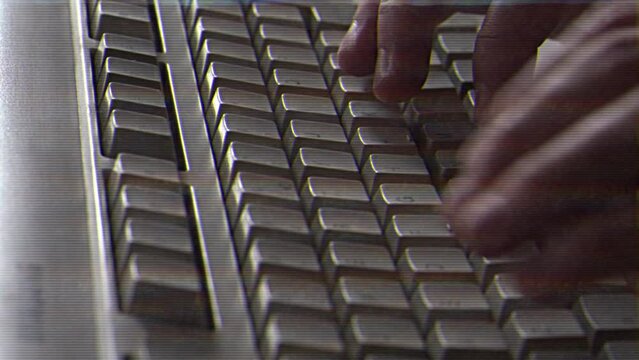 Computer engineer developer is working on old vintage computer 1990s. Antique classic pc keyboard and programmer typing hands. Internet web digital startup history. Outdated retro technology concept