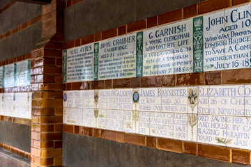 Ceramic tiles of the memorial to Heroic Self-Sacrifice, in Postman's Park, public garden near St Paul's Cathedral, London, United Kingdom