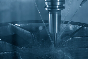 The CNC milling machine cutting  the aluminum alloy wheel part with liquid coolant method. - obrazy, fototapety, plakaty
