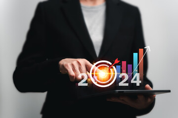 Business target and development concept, Businesswomen show goals target icon and business growth graph for the year 2024, Development digital marketing, banking, Investment financial