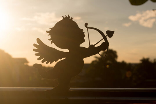 silhouette of a cupid on the sunset