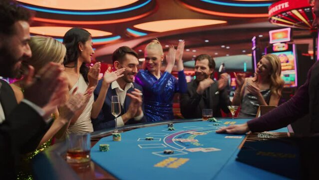Portrait of People Cheering and Celebrating the Winner of a Blackjack Game in a Modern Casino. Group of Diverse Friends Having Fun on a Night Out Together, Living the Thrill of Gambling. Vibrant Edit
