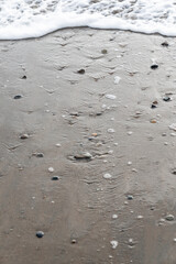 Beach with stones pebbles in dark sand Dominical Costa Rica