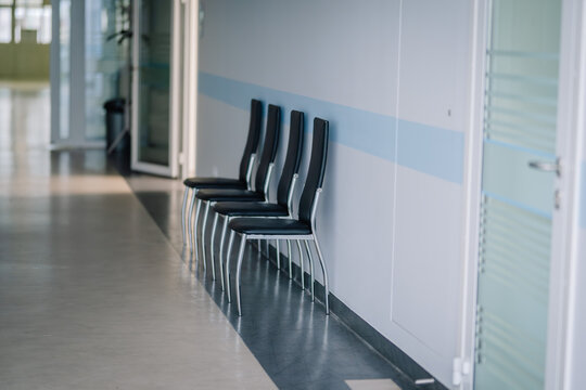  typical hospital waiting area with a row of empty seats and a clean, minimalistic design.