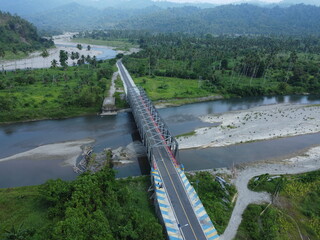 aerial views of the bridge and river as well as the forest