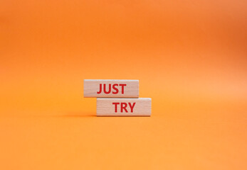 Just try symbol. Concept words Just try on wooden blocks. Beautiful orange background. Business and...