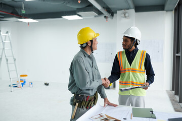 Positive architect and foreman shaking hands after meeting